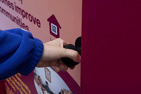 A person interacting with pop-up door in New York City