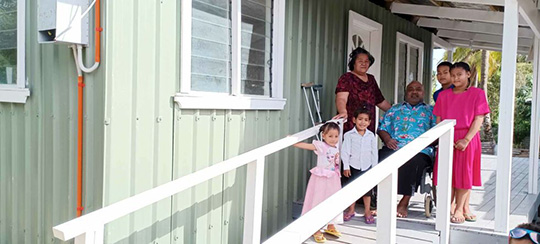 Sione and his family at their newly built home in Tonga